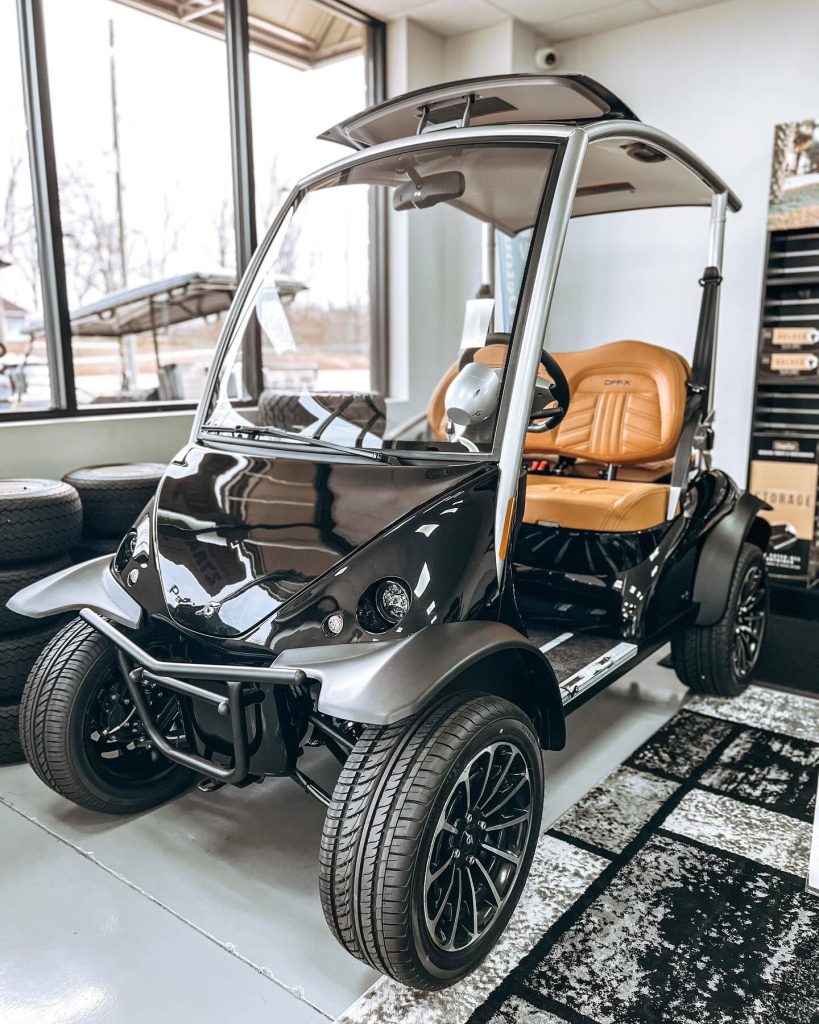 Black luxury golf cart with tan leather seats